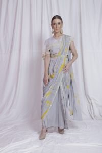Draped And Pre -Stitched Printed Saree With Ruffle Blouse And Hand Embellished Belt.